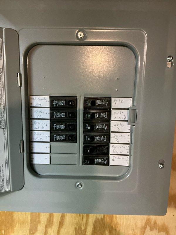 Conducted site assessment for mini split installation in garage. Evaluated existing electrical panel capacity and inspected access points in concrete block wall where current portable heater is located. Documented potential mounting locations and electrical requirements for new mini split system.