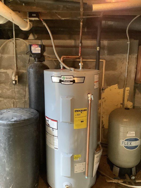 Responded to customer complaint of water pooling and freezing on patio at 150-year-old residence. Inspection revealed leak originating from water system in basement, specifically around connections between water heater and pressure tank. Repaired damaged pipe connections and replaced worn gaskets to restore proper system function, eliminating the source of leakage.