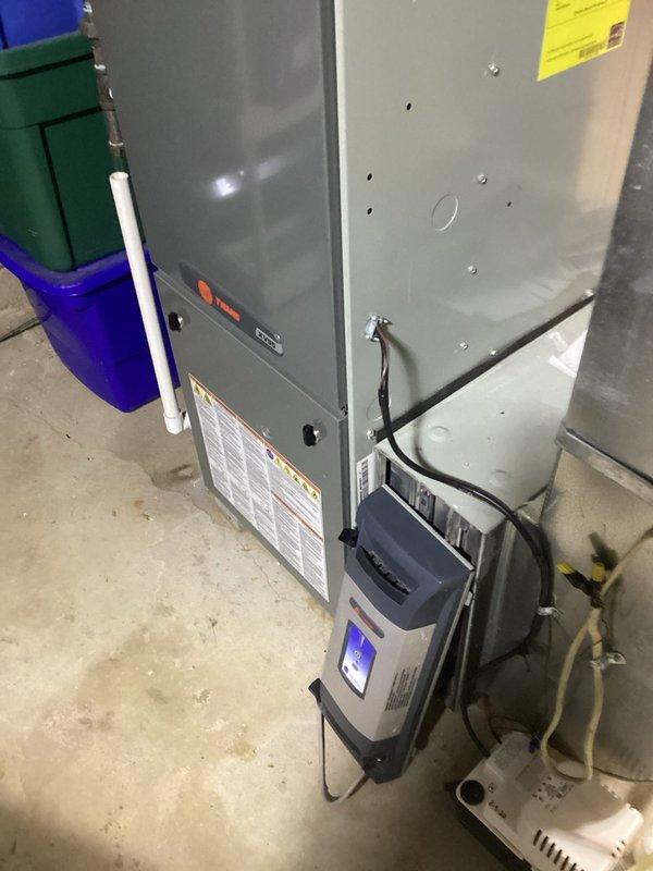 Performed routine maintenance on 14-year-old MVP furnace system. Inspected and cleaned evaporator coil/humidifier component with honeycomb mesh structure. Replaced Aprilaire 600 filter as requested and verified proper operation of attached air purification system.