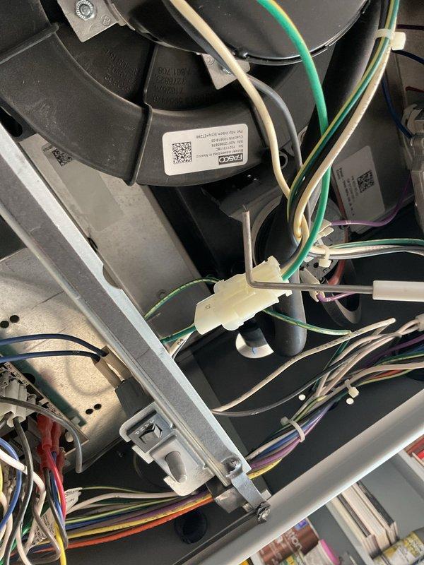 Performed routine maintenance on a 5-year-old furnace. Inspected blower motor assembly and electrical connections, confirming all wiring harnesses were properly secured with no signs of wear or damage. Conducted temperature differential testing with UEI EMT20 meter, obtaining readings of 35.36/64.01, which fall within normal operating parameters.