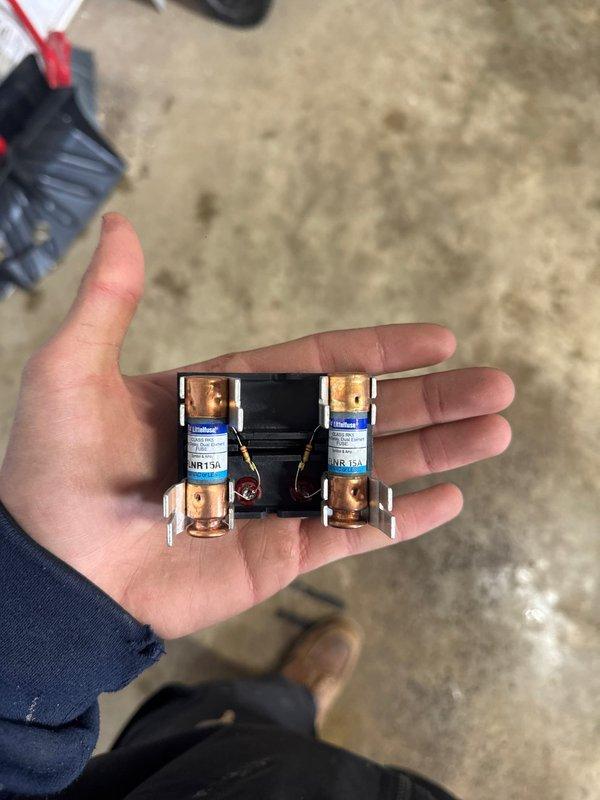 Completed installation of a Daikin mini-split system for garage application, including mounting the outdoor condenser unit on an elevated platform with proper electrical connections. Installed condensate drain line with PVC piping along exterior wall and verified electrical protection with appropriate 15A fuses.