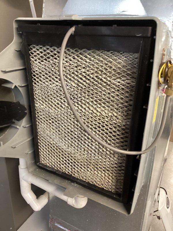 Performed scheduled MVP Heating maintenance service, which included inspection of the furnace system and associated components. Replaced dirty pleated air filters with new Naturalaire filters. Examined and cleaned the humidifier unit, checking the honeycomb evaporator pad and water supply connections for proper function.
