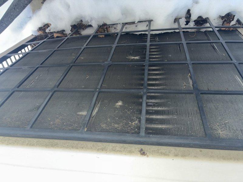 Performed routine maintenance on customer's mini-split system. Cleaned heavily soiled air filter that showed significant dust and debris accumulation. Inspected outdoor condenser unit which displayed dirt buildup and mildew formation along lower edge of protective grill; cleaned unit exterior to ensure proper airflow and system efficiency.