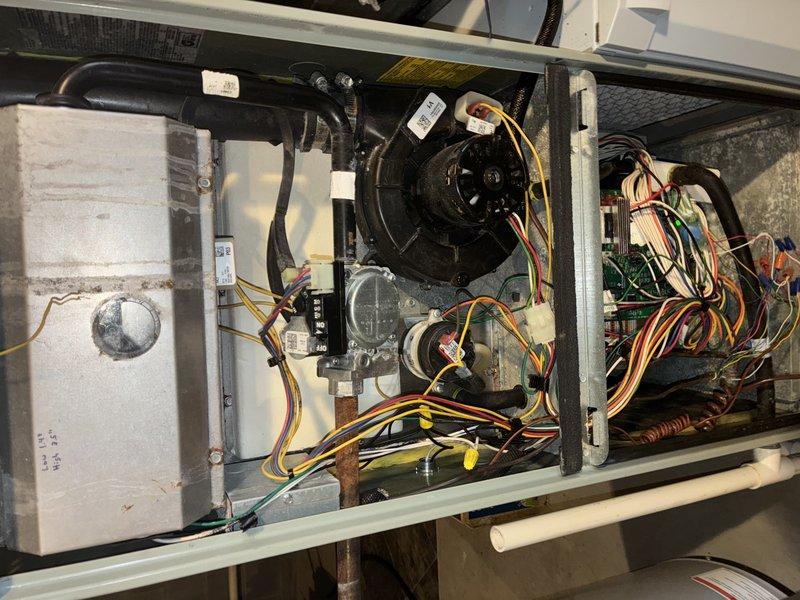 Performed scheduled heating maintenance visit. Discovered heavily clogged air filter with significant dust and debris accumulation. Inspected blower motor assembly and electrical connections, noting proper wire routing and component condition.