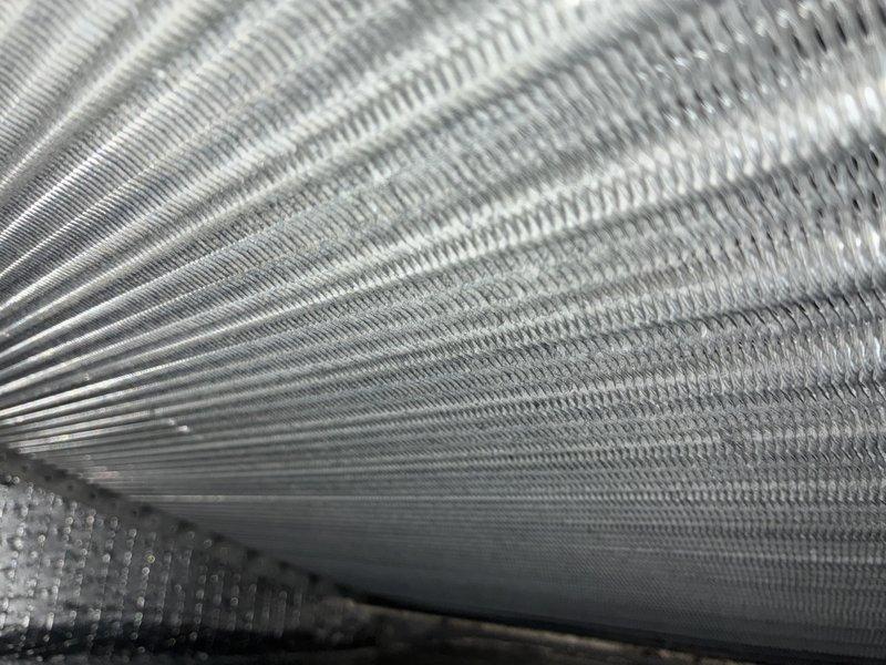 Performed routine furnace maintenance including inspection of evaporator coil assembly. Noted some dust accumulation and minor discoloration at connection points. Heat exchanger fins were examined and found to be in good working condition with no visible damage or significant debris. System is operating properly after service.