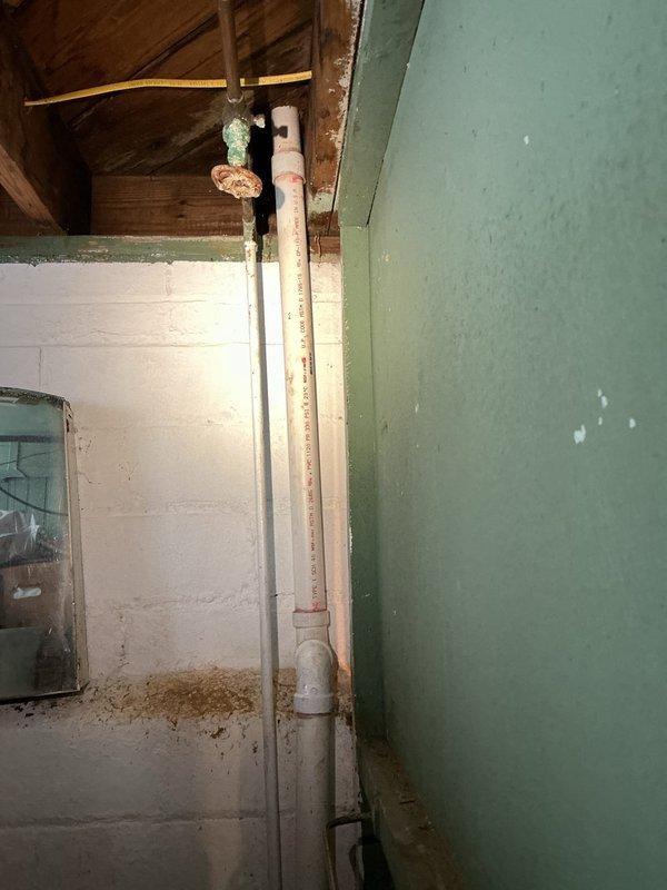 Responded to service call for clogged kitchen sink. Inspected under-sink PVC drain assembly and P-trap which showed signs of age. Located main drain connection in basement where copper fittings displayed mineral buildup and oxidation. Successfully cleared blockage and verified proper drainage function.