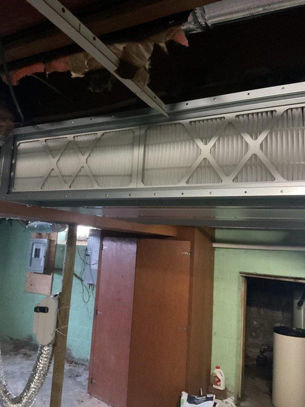 Completed mini split maintenance service by replacing all filters in the system located in the utility room. Removed old pleated filters with metal framing and installed new filters with proper diamond pattern arrangement. System now operating with improved airflow and filtration capacity.