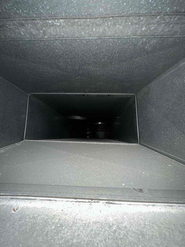 Completed comprehensive duct cleaning service in residential HVAC system, focusing on removal of accumulated dust and debris from main supply ducts. Visual inspection revealed moderate buildup on duct surfaces with some discoloration and residue on duct floors. All circular access points and ventilation pathways were thoroughly cleaned according to industry standards.