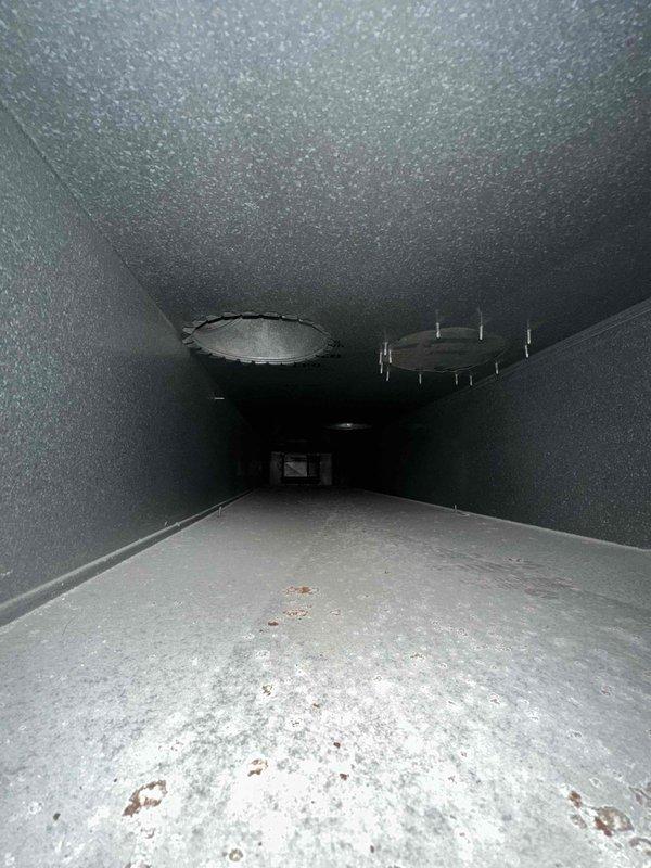 Completed comprehensive duct cleaning service in residential HVAC system, focusing on removal of accumulated dust and debris from main supply ducts. Visual inspection revealed moderate buildup on duct surfaces with some discoloration and residue on duct floors. All circular access points and ventilation pathways were thoroughly cleaned according to industry standards.