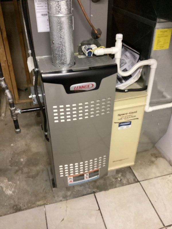 Performed routine maintenance on Lennox furnace system as part of MVP service program. Inspected air filtration components including the Space-Guard Air Cleaner, noting moderate dust accumulation on the pleated filter. System appears to be functioning properly with all connections intact and ventilation pathways clear.