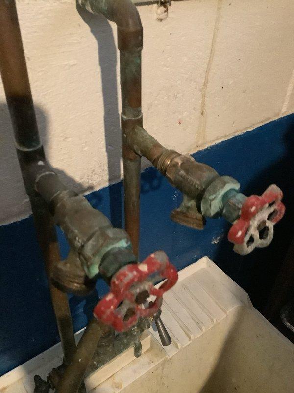 Responded to service call for cracked washer faucet. Upon inspection, found oxidized copper supply pipes with corroded brass fittings and shutoff valves. Replaced damaged washer and verified proper operation of faucet and valves.