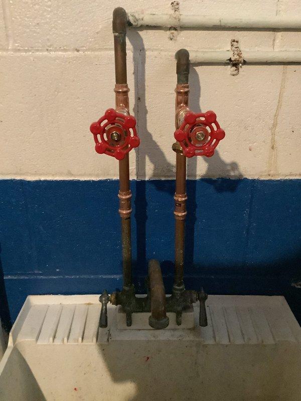 Responded to service call for cracked washer faucet. Upon inspection, found oxidized copper supply pipes with corroded brass fittings and shutoff valves. Replaced damaged washer and verified proper operation of faucet and valves.