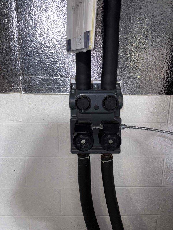 Conducted geothermal system assessment at Alice's residence where her son-in-law lives. Inspected existing ClimateMaster geothermal unit and circulation pump assembly mounted on concrete block wall. Took measurements of equipment and documented current installation configuration to prepare comprehensive estimate for system replacement or upgrade.