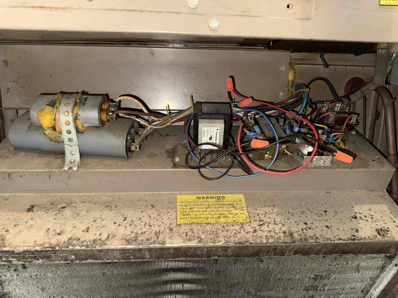 Performed comprehensive furnace tune-up on aging heating system. Inspected electrical connections and wiring in control compartment, noting multiple colored wires with orange wire nuts showing signs of disorganization. Examined heat exchanger components and replaced customer's 14x25x1 air filter to improve system efficiency.