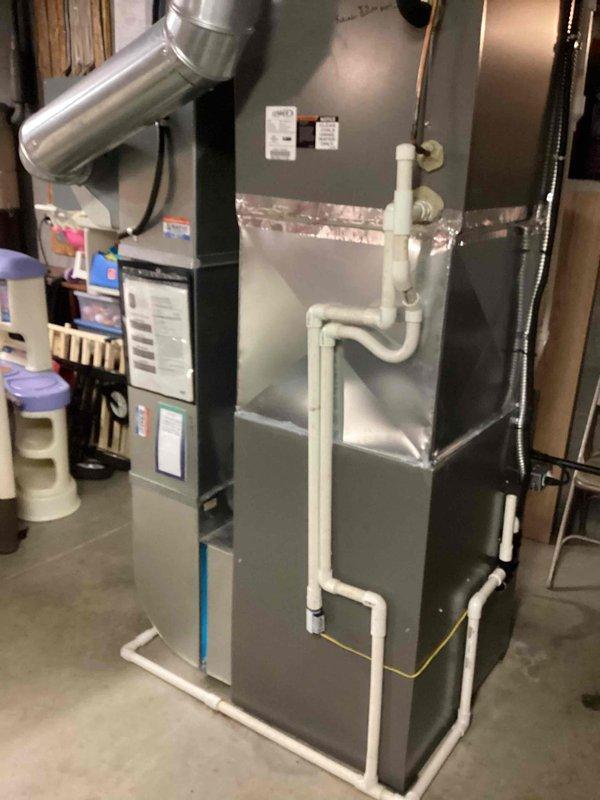 Performed scheduled MVP Heating maintenance visit on residential furnace system. Inspected gray HVAC furnace unit with PVC drainage components and verified proper ductwork connections. Equipment was found in good working condition with no visible issues or anomalies.