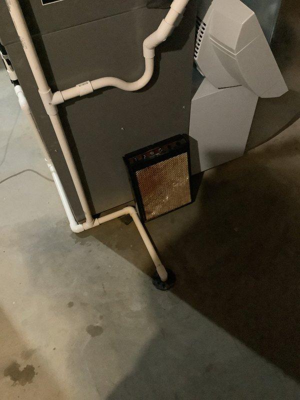 Responded to customer-reported humidifier leak. Inspected HVAC system in basement area, noting water staining on concrete floor beneath the unit. Serviced leaking humidifier (Aprilaire 5000 model) and replaced the existing metal mesh filter. Discussed replacement options for furnace filter, with customer requesting hospital-grade filtration; advised that specialized filter may need to be ordered.