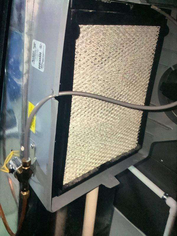 Performed scheduled MVP heating maintenance service on 6-year-old system. Inspected evaporator coils showing dust accumulation and identified significant rust/corrosion in the drain pan. Examined humidifier pad and connecting components, noting condition of brass fittings and copper tubing.