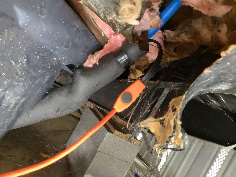Installed heat tape on exposed main line piping and replaced piping from meter up to the PEX connection at hot water heater. Accessed confined area with existing insulation to complete the installation, ensuring protection against freezing for exposed plumbing components. Work included connecting new piping to existing meter and properly securing all connections.