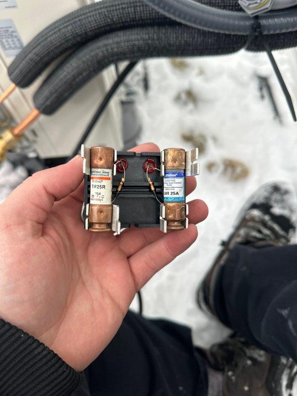 Installed mini split system with interior wall-mounted air handler in client's space. Verified electrical connections, including proper fuse installation in disconnect box. Parts inventory noted as partial (2/5) with remaining components stored at shop for future installation phase.