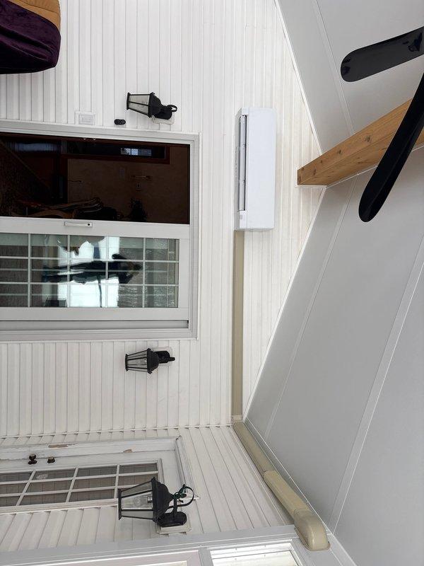 Installed mini split system with interior wall-mounted air handler in client's space. Verified electrical connections, including proper fuse installation in disconnect box. Parts inventory noted as partial (2/5) with remaining components stored at shop for future installation phase.