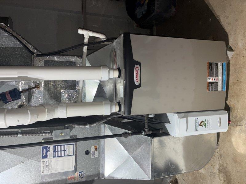 Performed routine heating maintenance on 4-year-old Lennox furnace system that was rescheduled from 12/18. Inspected the basement installation including furnace unit, air handler, PVC venting, and electrical connections. Checked and verified filter condition, which showed proper maintenance with minimal dust accumulation and intact pleated structure.