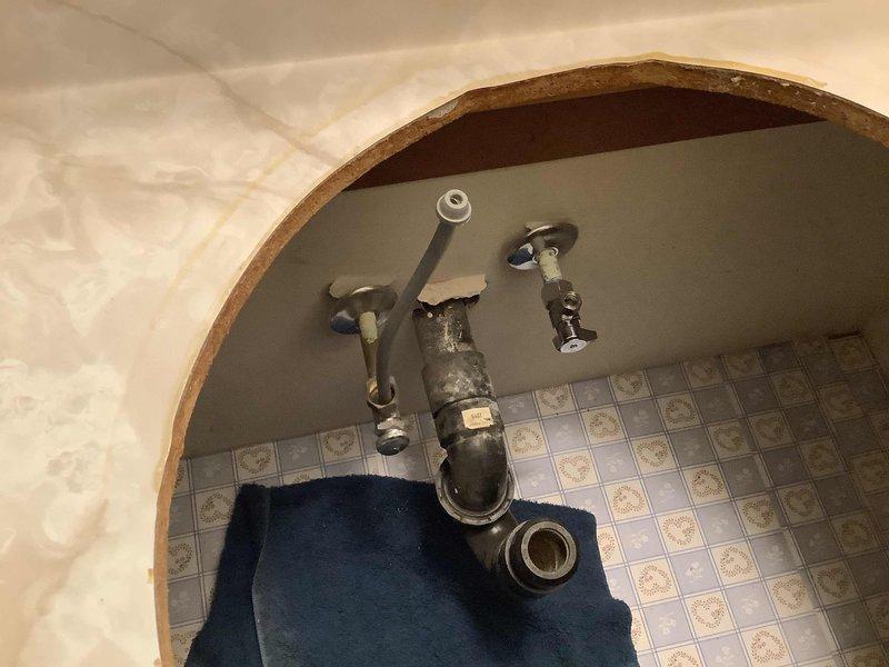Responded to service call for a bathroom faucet leak. Inspected aging plumbing components under the sink, including corroded drain assembly and water supply valves. Replaced faulty valve components and repaired leaking faucet to restore proper functionality.