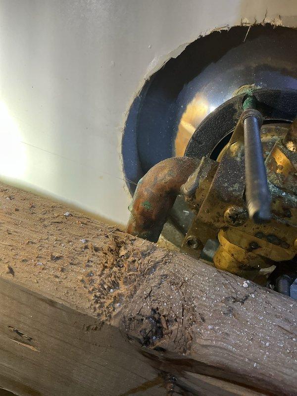 Returned to complete assessment following restoration work. Inspected exposed wall section revealing significant corrosion on copper pipe elbow within the plumbing assembly. Documented condition of brass valve connections and vertical piping through wooden framing structure. Evaluation completed for necessary faucet repairs.