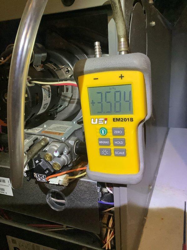 Performed routine MVP heating maintenance visit. Conducted system diagnostics with UEi EM201B gauge, obtaining pressure reading of +3584. Inspected furnace filter which showed significant dust accumulation, indicating replacement is needed soon.