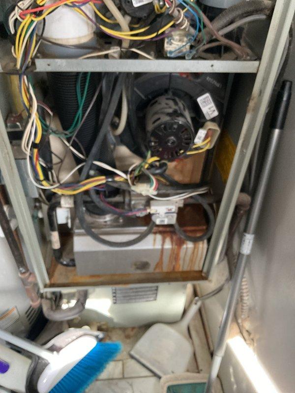 Responded to service call for a 14-year-old furnace displaying error code 1026 on thermostat and 4 red flashing lights on the control board. Upon inspection, found significant corrosion and rust damage on the lower cabinet area, indicating moisture accumulation over time. Diagnosed faulty control module, replaced component, and verified proper system operation with no error codes present.