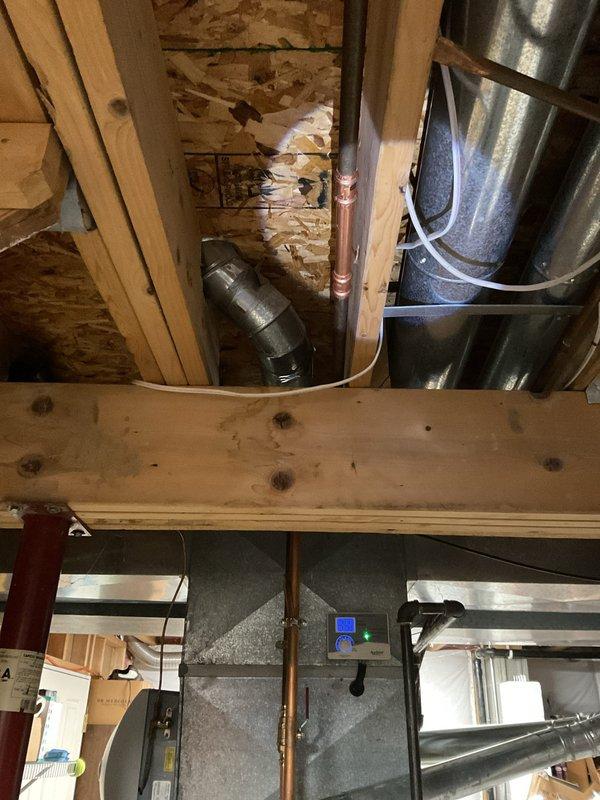 Replaced leaking 40-gallon short water heater, installed new ball valve, and relocated expansion tank by coupling line together in ceiling. Repositioned expansion tank between water heater and ball valve to improve system function. Installed short riser before flue 90s to address observed backdraft issues around the flue.