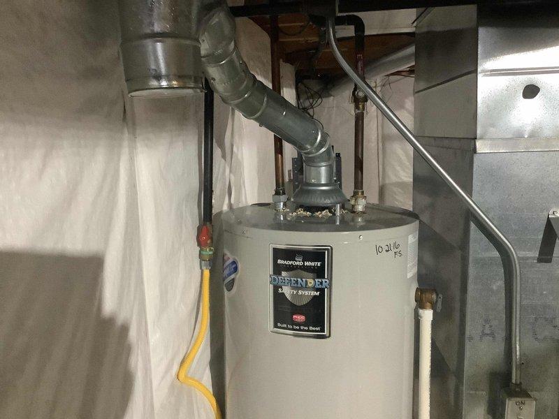 Replaced failed water heater with new 40-gallon Bradford White Defender tall model. Installation included new ball valve and expansion tank per estimate. Unit properly connected to existing gas line and venting system with all necessary components staged and installed according to manufacturer specifications.