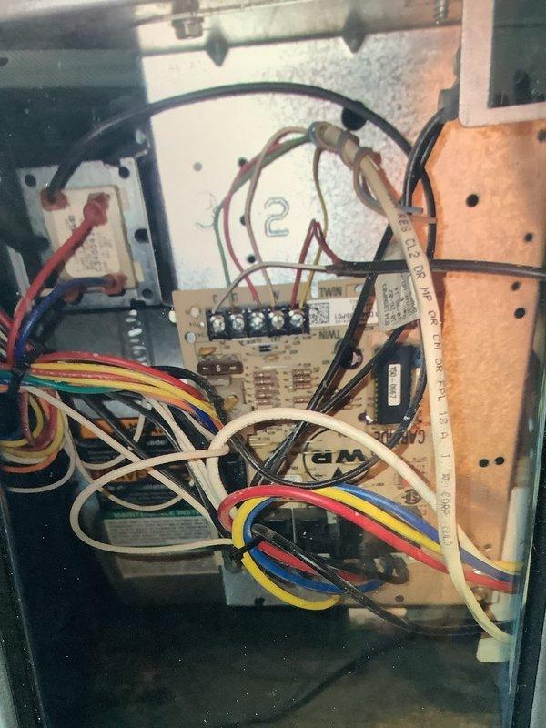 Performed diagnostic service on 23-year-old residential furnace that was non-operational. Inspection revealed accumulated dust on blower wheel and examined electrical connections at control board where multiple wires (red, yellow, blue, white, green) were properly terminated. Cleaned components and restored system to working condition.