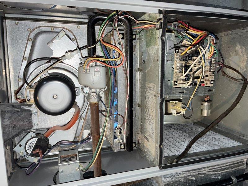 Serviced a Goodman natural gas furnace reporting no heat. Upon inspection of the aging unit, identified faulty control board connections and misaligned blower motor as root causes. Repaired electrical connections, realigned blower assembly, and verified proper heating operation through complete system test.
