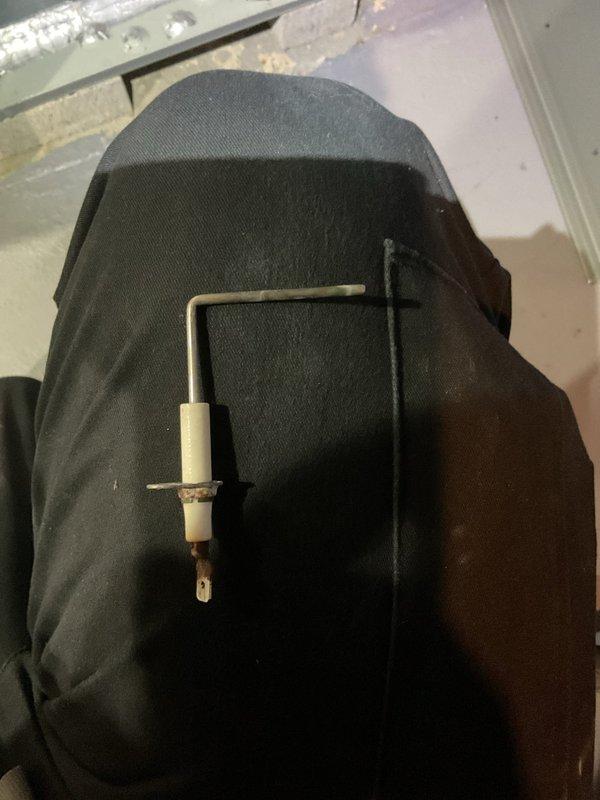 Performed comprehensive furnace tune-up service including inspection and cleaning of ignition electrode assembly. Removed and examined spark igniter, noting minor wear and discoloration at the tip indicating normal operational use. Reinstalled component after verification of proper functionality to ensure reliable heating system operation.