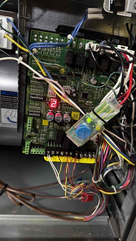 Successfully replaced warranty control board on HVAC system. Installed new green PCB with dual connector blocks (pins 1-8 and 9-15) and verified proper operation of the digital display. All wiring connections were properly secured and system functionality was confirmed.