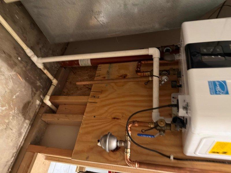 Performed scheduled maintenance on customer's tankless water heater system. Inspected all connections and fittings for proper operation, including copper supply lines, pressure regulator, and expansion tank. Confirmed Energy Star unit was functioning correctly with no leaks or anomalies detected in the basement installation.