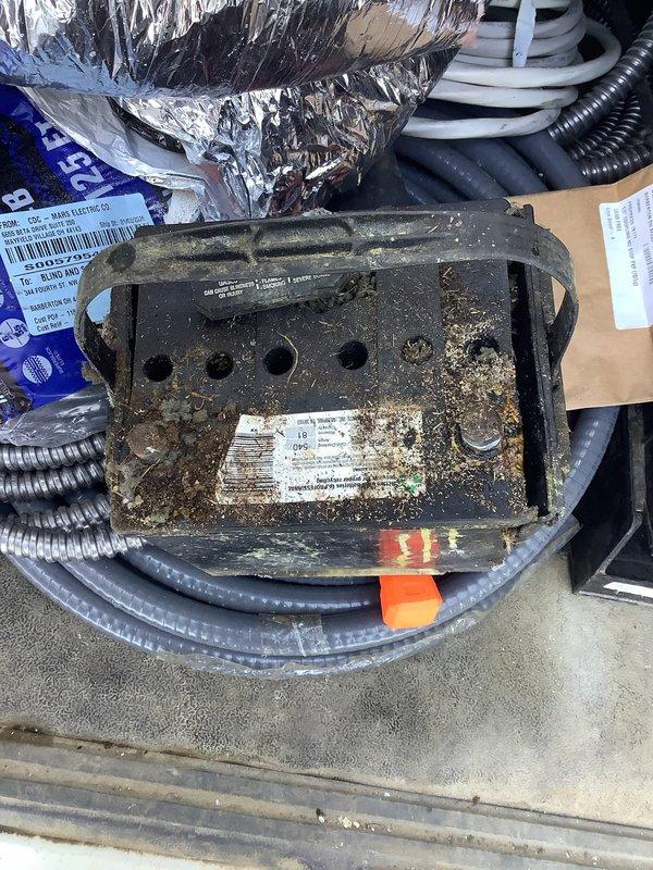 Responded to service call for non-operational 16kW Generac generator (18 years old). Upon inspection, discovered severe corrosion and environmental damage to the electrical connection box. Unit completely non-functional due to deteriorated electrical components. Access to unit required traversing through snow-covered terrain.