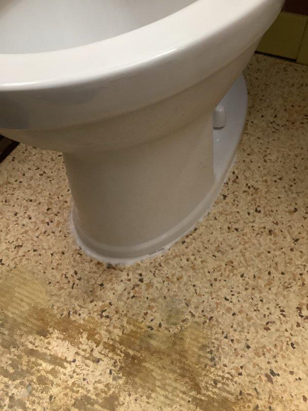 Completed installation of new American Standard Champion toilet (comfort height, elongated bowl, 1.6 GPF) as quoted. Removed old toilet showing significant floor staining and drain discoloration. Properly sealed new unit to floor with appropriate caulking to prevent future water damage.