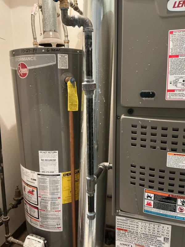 Responded to customer report of gas odor following recent furnace and gas line installation. Performed inspection of the mechanical room containing Rheem water heater and furnace system. Identified leak at threaded 90-degree elbow joint on newly installed gas piping. Customer had already contacted gas company who shut down furnace for safety. Noted that AC installation is still pending completion.