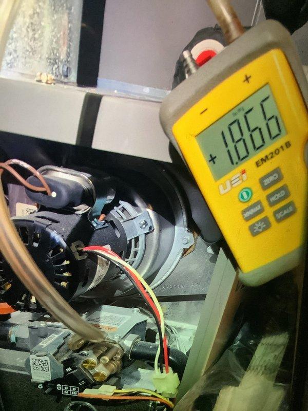 Performed scheduled MVP Heating maintenance service on 5-year-old system (rescheduled from previous dates). Conducted comprehensive system inspection including refrigerant line assessment and pressure testing. Performed electrical diagnostics with EM2018 meter showing 186V reading at blower motor assembly, confirming proper voltage supply to unit.