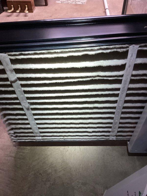 Performed routine maintenance on heating system as part of MVP Heating recurring service. Inspected air filter showing moderate dust accumulation on striped filtering surface, and examined secondary filter assembly with diamond-pattern grid which appeared clean and in good condition. All connections and components were verified to be properly secured and functioning normally.