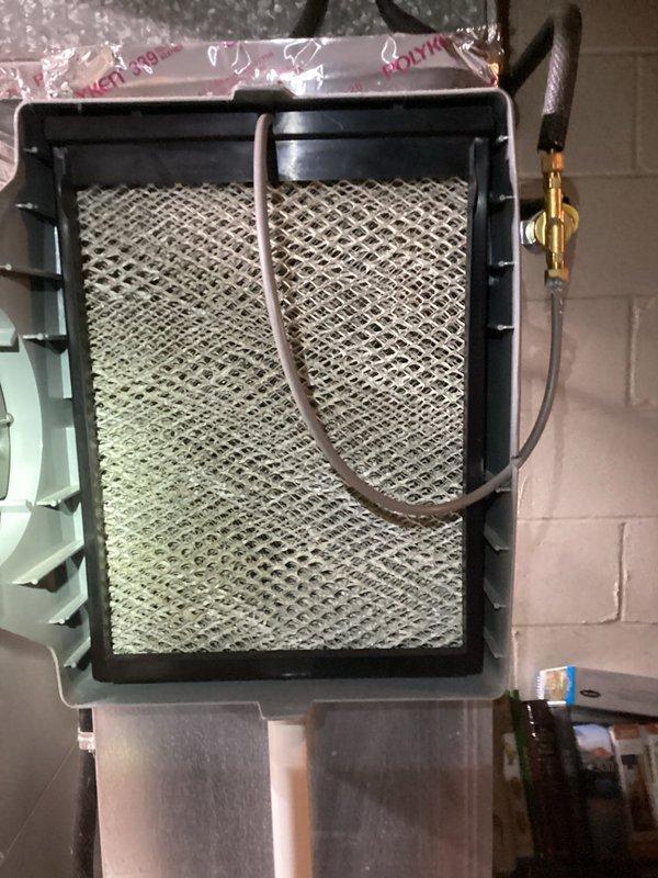 Performed routine maintenance on heating system as part of MVP Heating recurring service. Inspected air filter showing moderate dust accumulation on striped filtering surface, and examined secondary filter assembly with diamond-pattern grid which appeared clean and in good condition. All connections and components were verified to be properly secured and functioning normally.