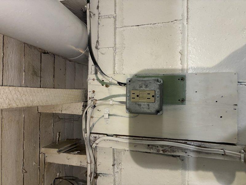 Responded to service call for non-functional outlet in century-old unoccupied residence. Inspection revealed deteriorated wiring connections in junction box mounted on basement cinder block wall. Repaired faulty connections and tested outlet to confirm proper operation and voltage.