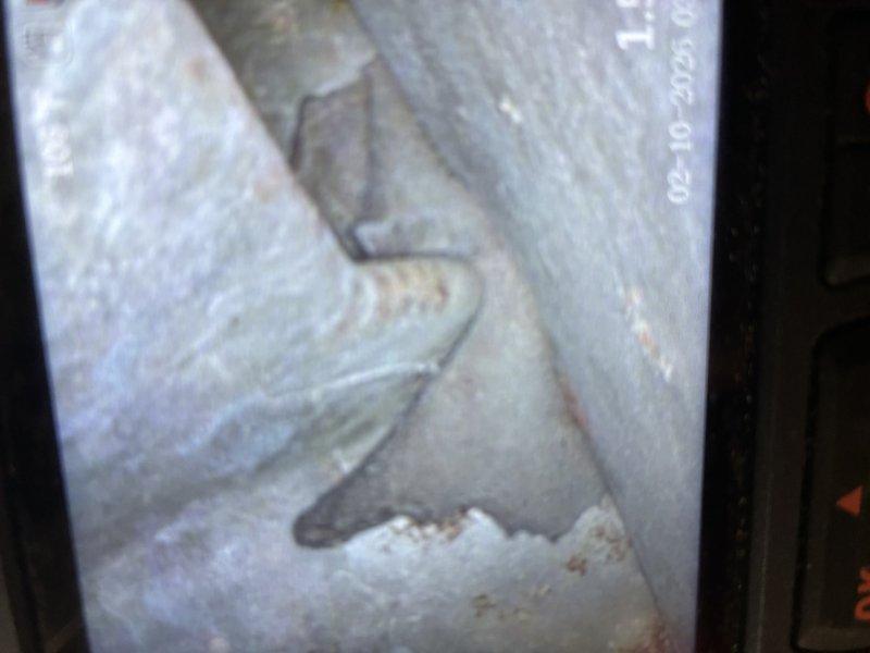 Responded to service call for 16-year-old furnace exhibiting premature burner shutoff and alternating diagnostic lights. Performed visual inspection of heat exchanger using inspection camera, revealing signs of wear and possible mineral deposits. Exterior inspection of connected heat pump system showed normal winter conditions with adequate clearance despite snow accumulation.
