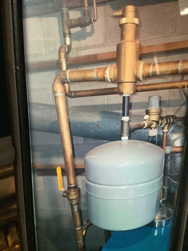 Performed scheduled maintenance on boiler system. Identified and tightened leaking brass union on top of boiler to stop dripping. Inspected pressure gauges and copper piping network, confirming proper system operation post-repair.