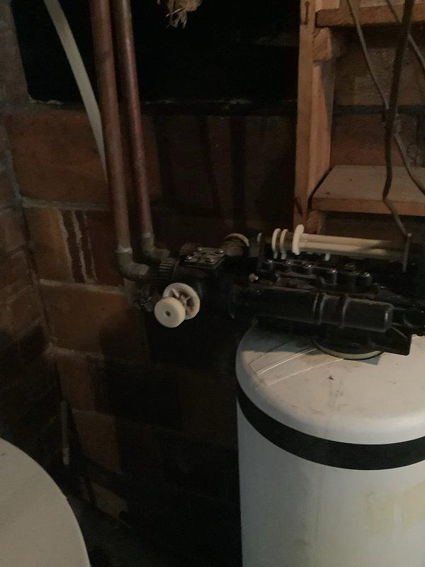 Successfully disconnected existing water softener system from residential plumbing as requested. Equipment included dual-tank setup with control valve assembly and copper/PVC pipe connections. No additional repairs performed as per customer instructions.
