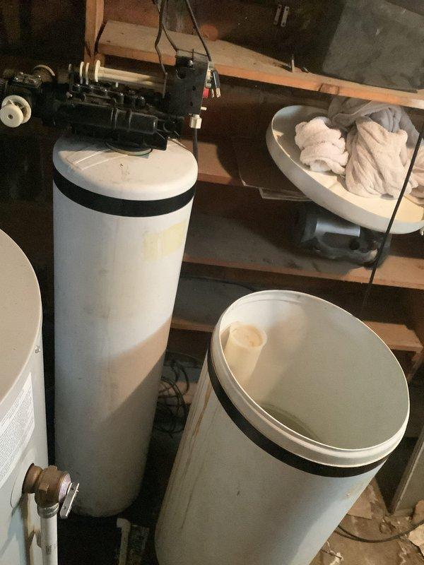 Successfully disconnected existing water softener system from residential plumbing as requested. Equipment included dual-tank setup with control valve assembly and copper/PVC pipe connections. No additional repairs performed as per customer instructions.