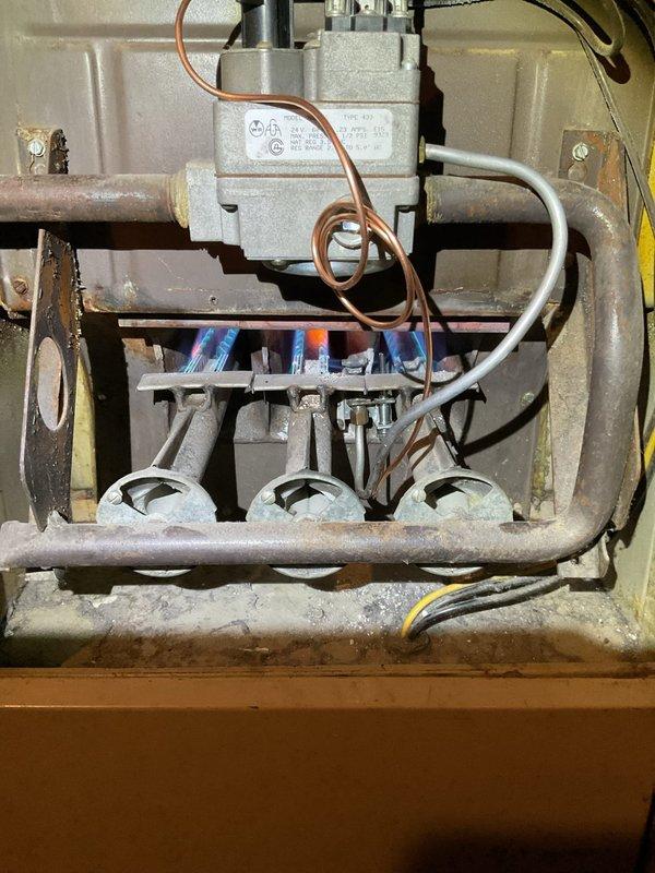 Responded to no-heat service call for 20-year-old Lennox furnace. Upon inspection, found system operational with proper flame pattern at burner assembly, showing normal blue flames with orange tips. Tested gas valve functionality and verified all components of the heating system were working correctly. Customer advised about age-related concerns and recommended considering replacement options in near future due to system's advanced age.
