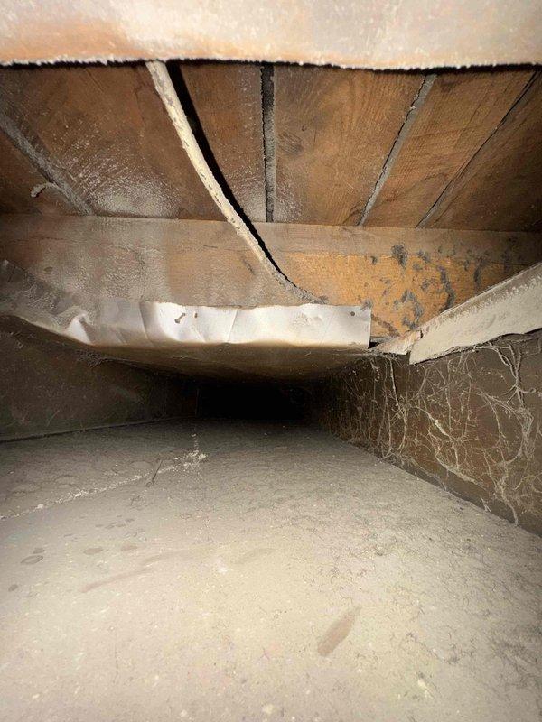 Performed comprehensive duct cleaning service on HVAC system, addressing significant dust and debris accumulation in metal ductwork and crawl space access points. Successfully cleaned and sanitized all vents, removing built-up contaminants from duct seams and corners to improve system efficiency and indoor air quality.