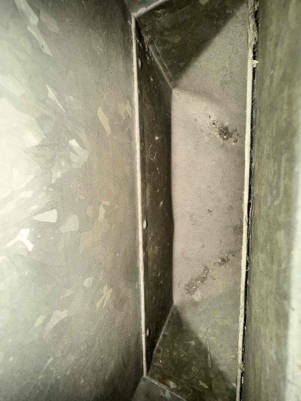 Performed comprehensive duct cleaning service on HVAC system, addressing significant dust and debris accumulation in metal ductwork and crawl space access points. Successfully cleaned and sanitized all vents, removing built-up contaminants from duct seams and corners to improve system efficiency and indoor air quality.